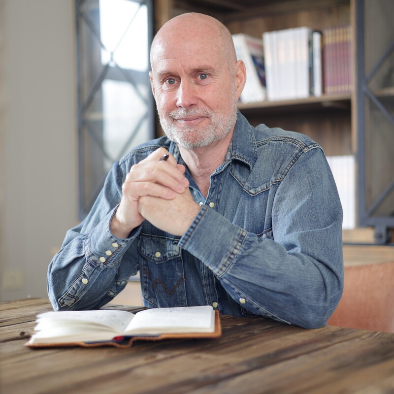 Michael Henderson Headshot with book
